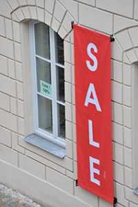 Red hanging banner with Sale printed on it