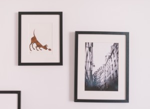 Artwork of a dog and buildings on a white wall